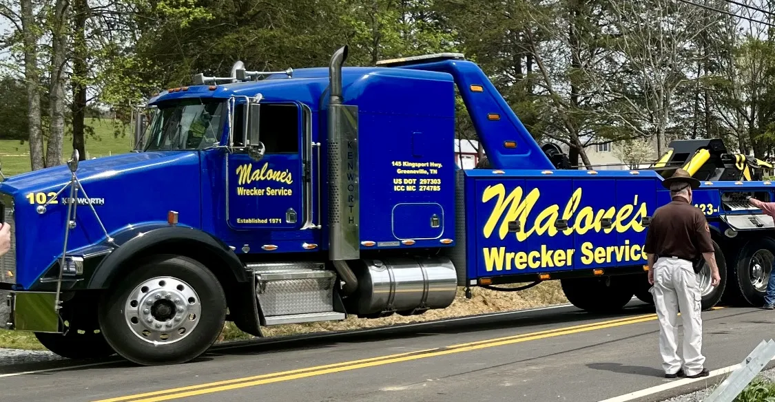 Malone’s blue Kenworth heavy wrecker, number 102, with Established 1971 on the door.